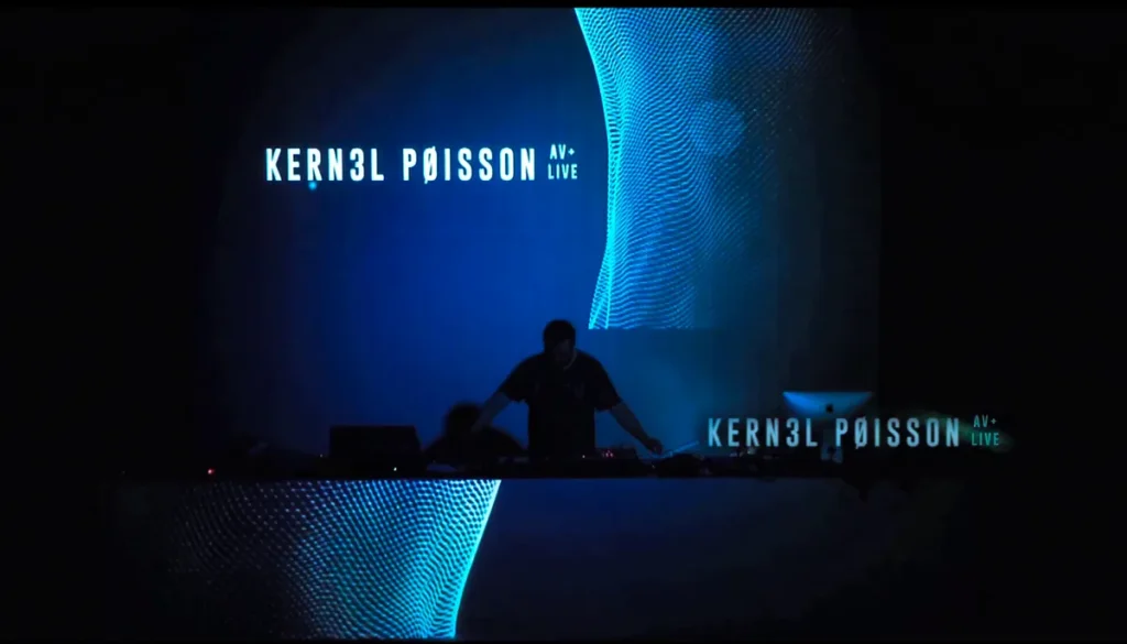K3rn3l Pøissøn performing an audiovisual live set with blue projections at Celobert Festival in Barcelona.